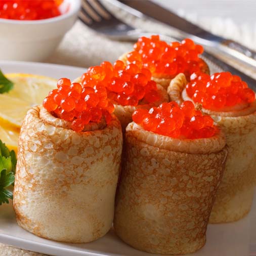 Pancakes with red caviar.